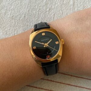 Gucci Women's Black and Gold Watch